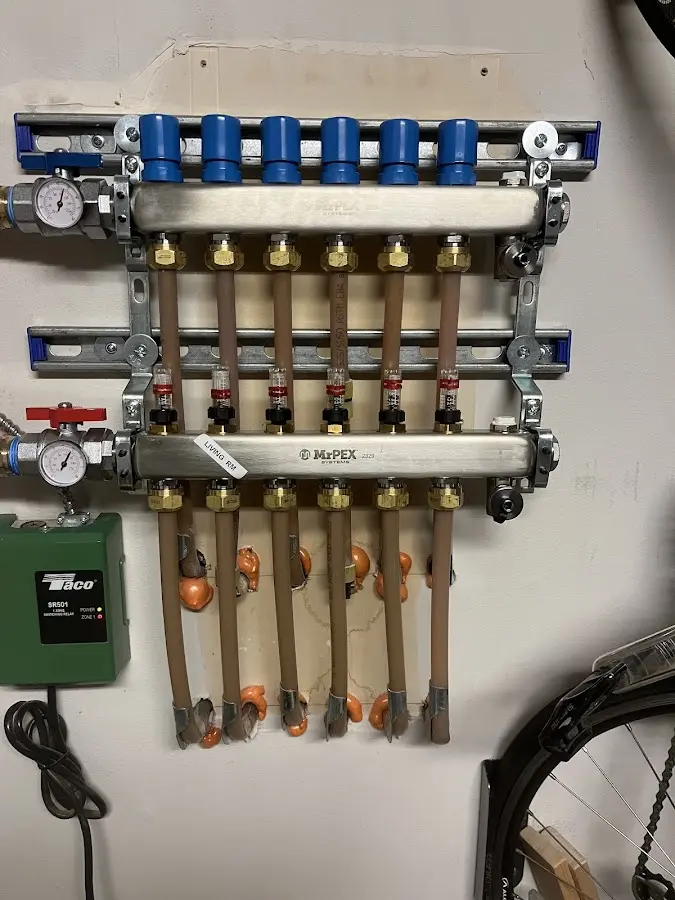 Plumber performing Water Heater Repair at a residential property in Elon